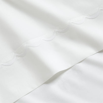 White percale sheet set with a delicate scallop stitched edge.