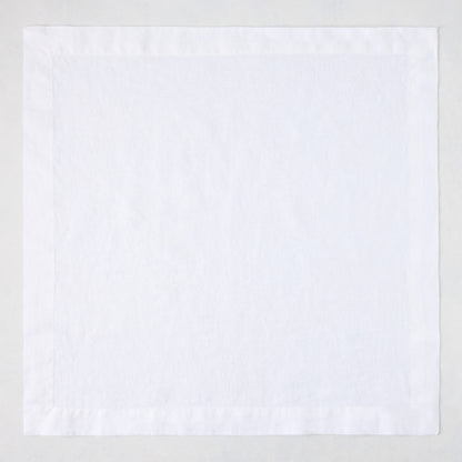 White HG Signature hand-dyed 22-inch square linen napkin with mitered corners.
