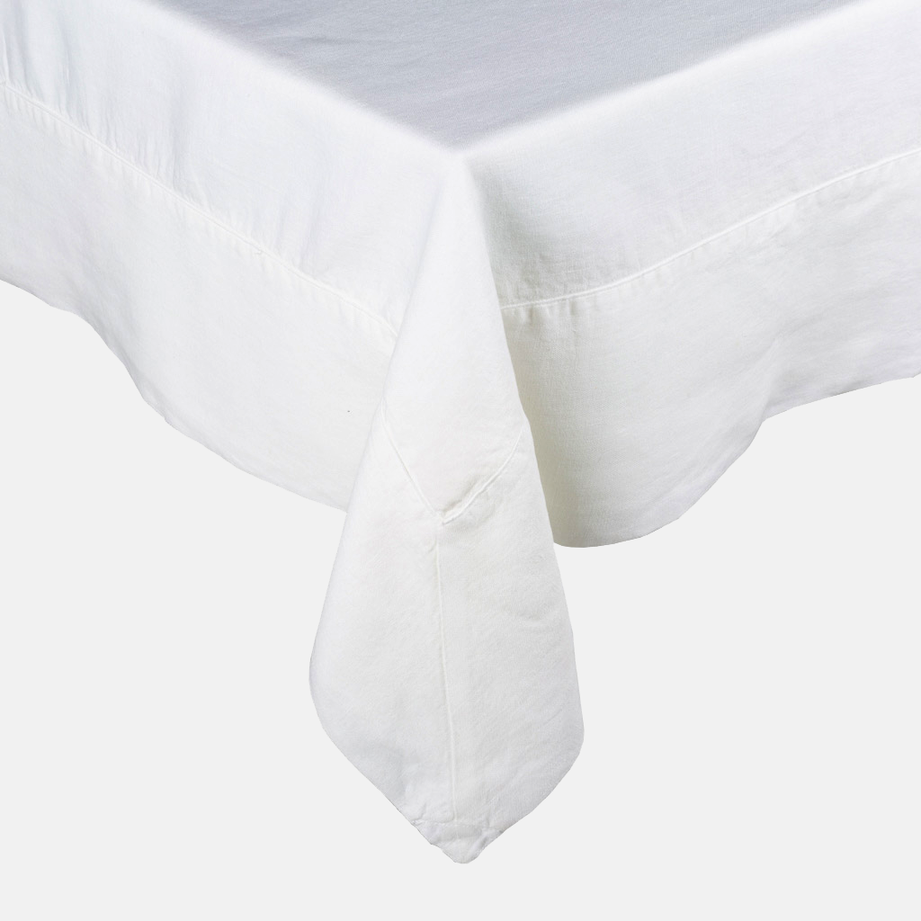 White HG Signature Hand-dyed Linen Tablecloth with generous border and mitered corner detailing.