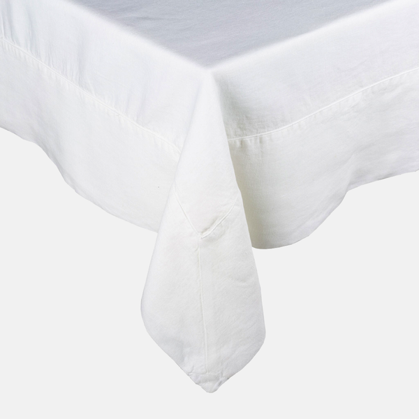 White HG Signature Hand-dyed Linen Tablecloth with generous border and mitered corner detailing.