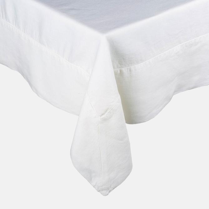 White HG Signature Hand-dyed Linen Tablecloth with generous border and mitered corner detailing.