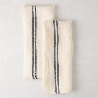 Set of 2 white French linen hand towels with black stripes, folded on a light surface.