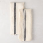 Set of 2 white French linen hand towels with black stripes, folded on a light surface.