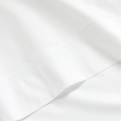 White percale sheet set with a thin triple stitch detail on the hem.