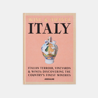 Hardcover book "Wine & Travel Italy" with a peach cover, gold title, and a colorful painted vase.