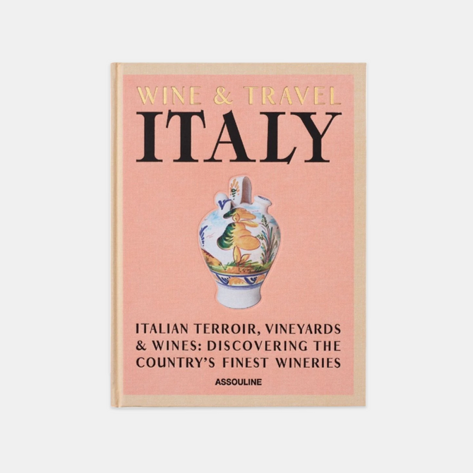 Hardcover book "Wine & Travel Italy" with a peach cover, gold title, and a colorful painted vase.