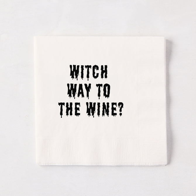 White 5.5-inch square 3-ply paper cocktail napkin with black dripping text reading Witch Way to the Wine.