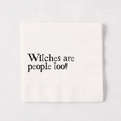 White 5.5" square paper napkin with "Witches are people too!!" in black text.