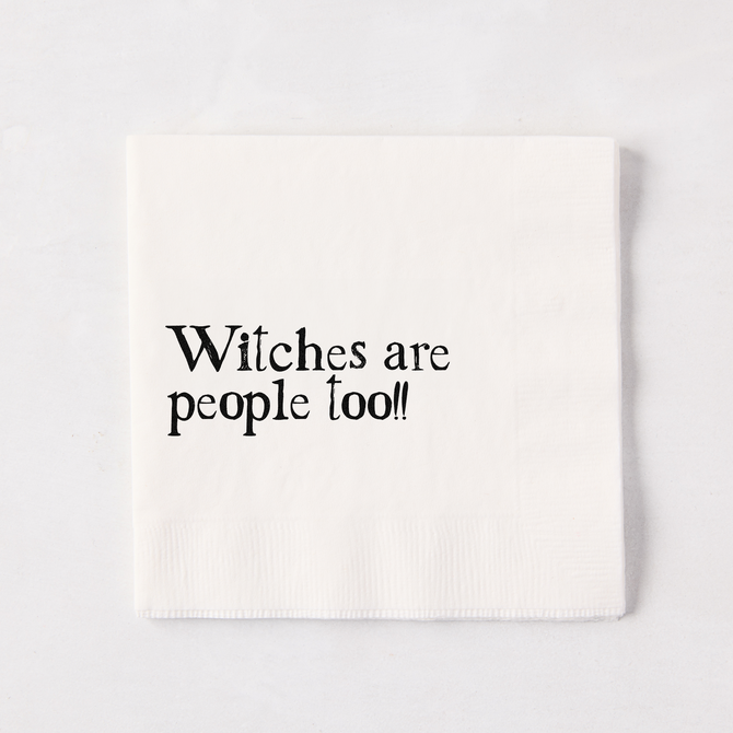 White 5.5" square paper napkin with "Witches are people too!!" in black text.
