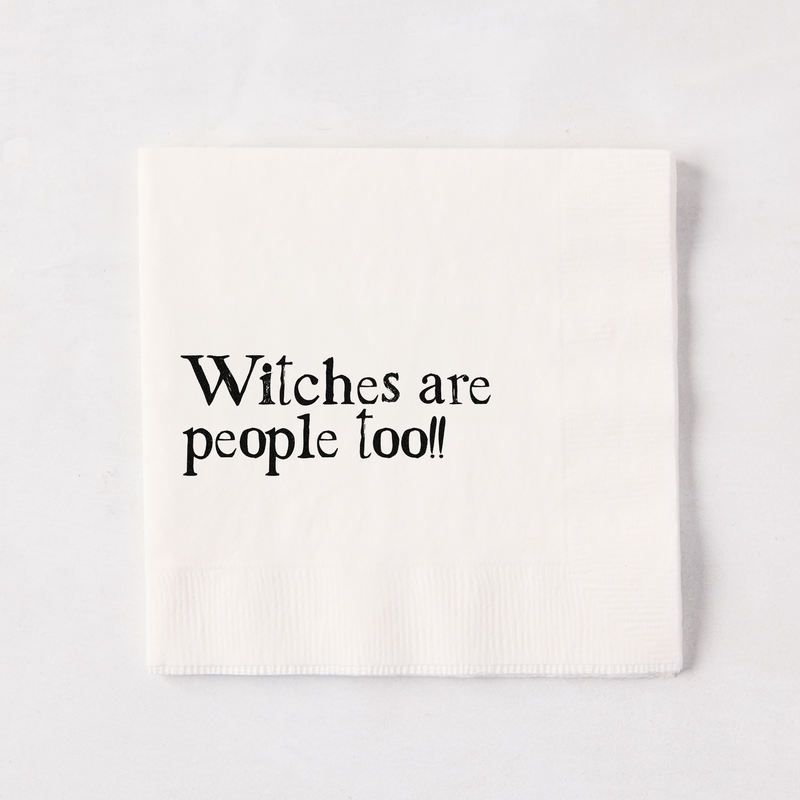 White 5.5" square paper napkin with "Witches are people too!!" in black text.