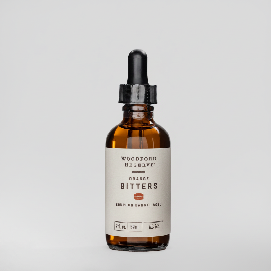 Woodford Reserve Orange Bitters in a small amber glass bottle with a black dropper cap and cream label.