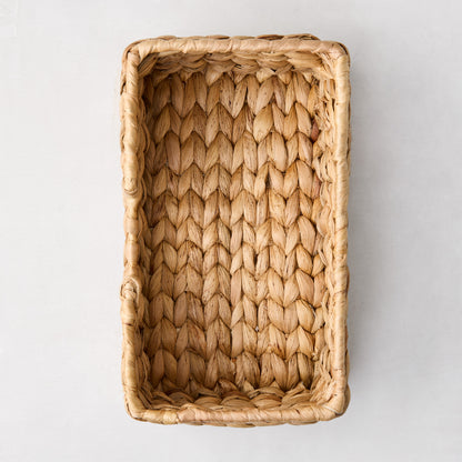 Woven hyacinth hand towel holder, rectangular, natural light brown, tightly woven texture.