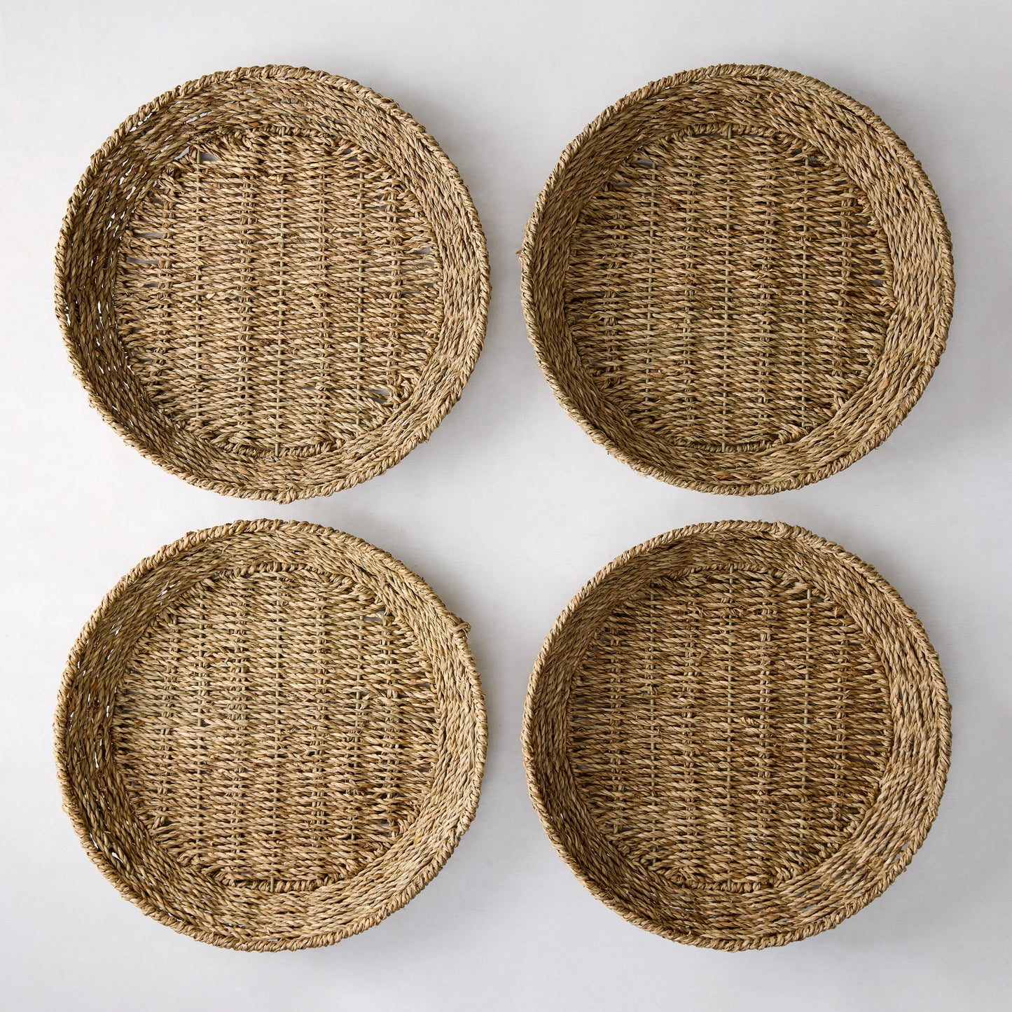 Set of 4 round woven seagrass plates with natural texture, 12.75"Dia.