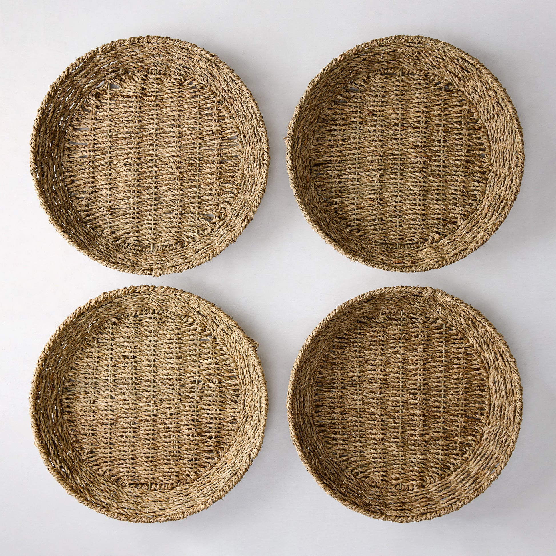 Set of 4 round woven seagrass plates with natural texture, 12.75"Dia.