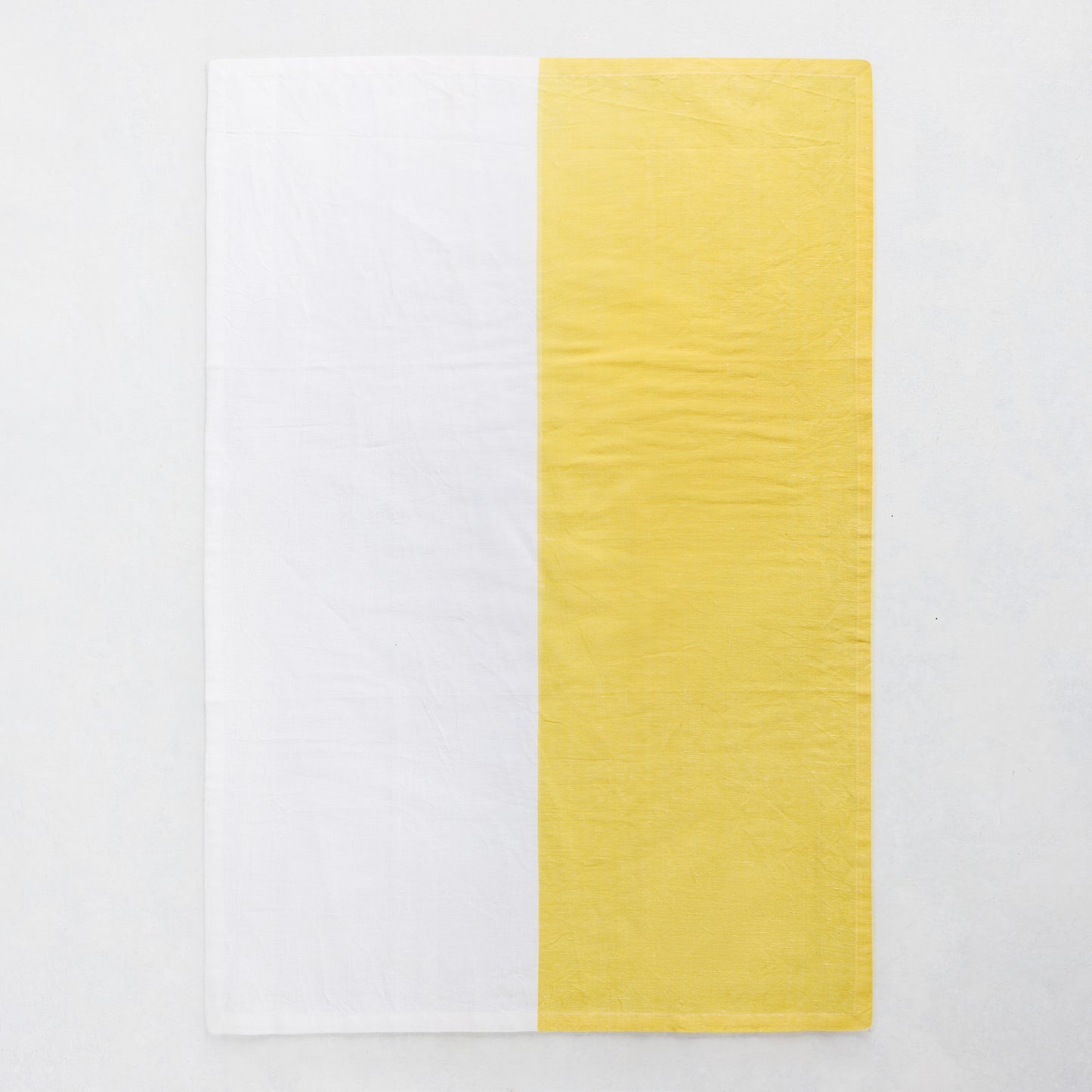 Yellow and white half-patterned cotton-linen hand towel, block print style.