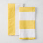 Set of 2 yellow and white block print cotton-linen hand towels; one striped, one half yellow/half white.