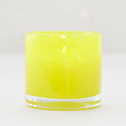 Bright yellow glass votive candle holder, 2.75" tall, with a clear base.