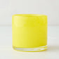 Bright yellow glass votive candle holder, 2.75" tall, with subtle swirled texture.