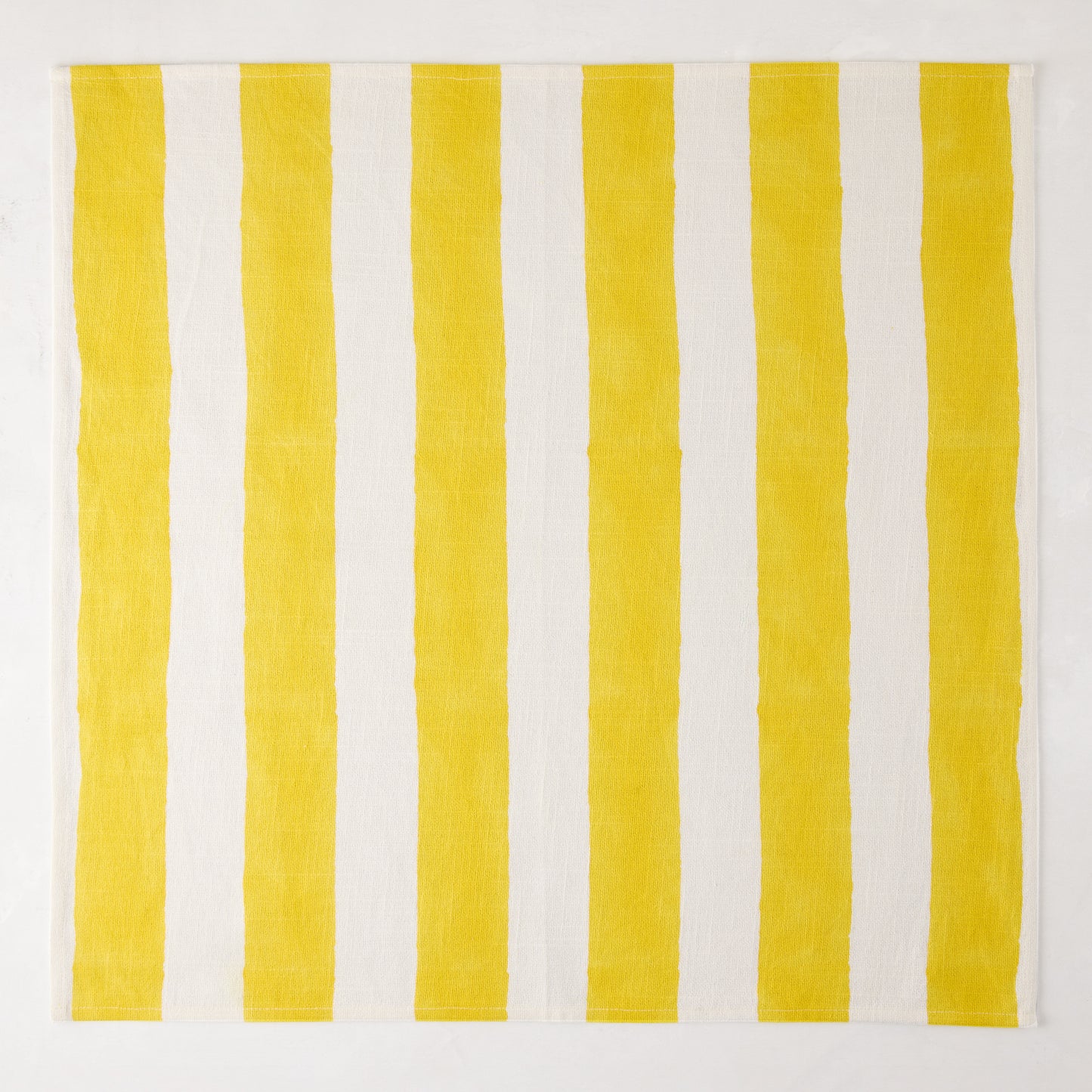 Yellow Hampton Stripe Cotton Napkin, 22" square, with bold yellow and white vertical stripes.