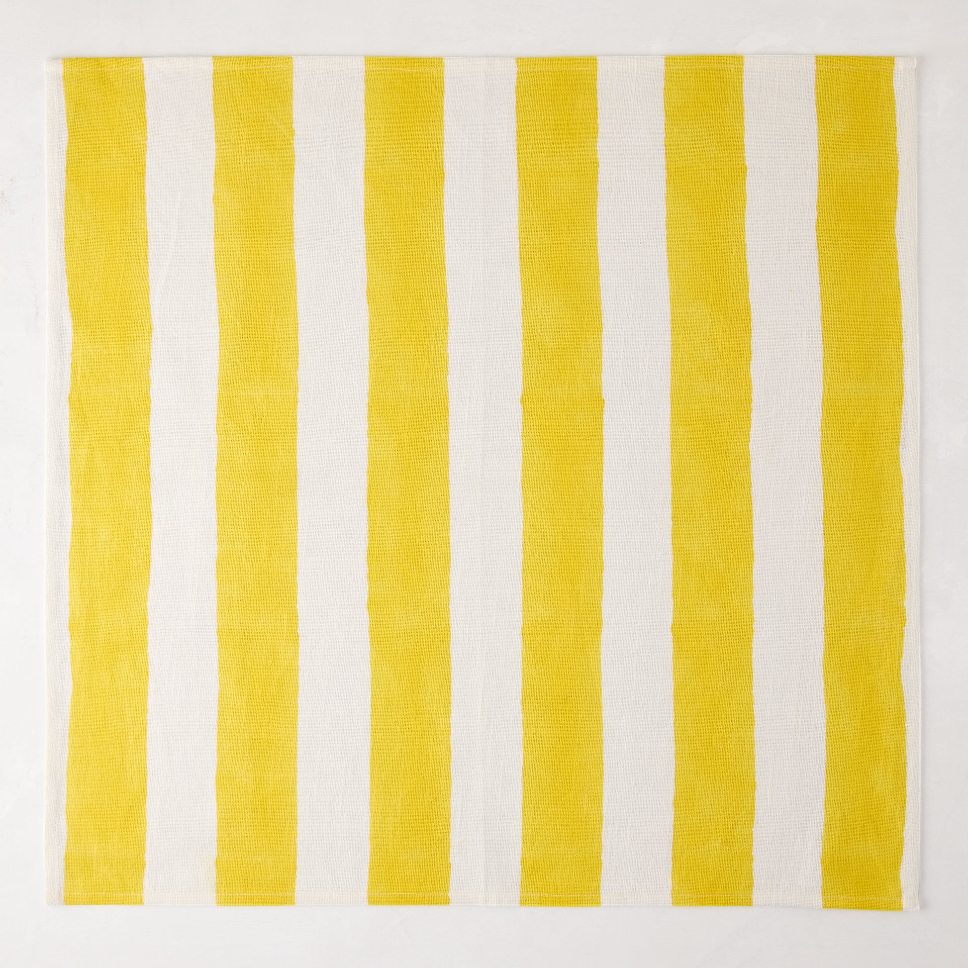Yellow Hampton Stripe Cotton Napkin, 22" square, with bold yellow and white vertical stripes.