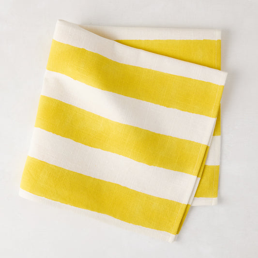 Yellow Hampton Stripe Cotton Napkin, 22" square, folded with bold yellow and white stripes.