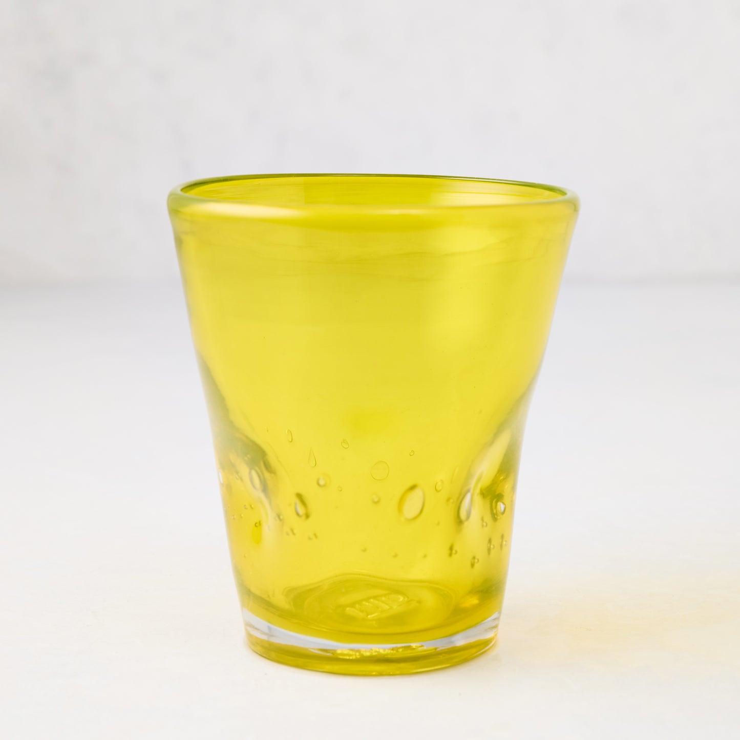 Yellow Henri 8 oz. mouth-blown glass with unique imperfections and air bubbles.