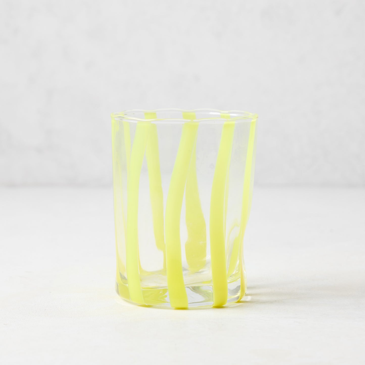 Hand-made Italian double old fashioned glass with vertical yellow stripes.