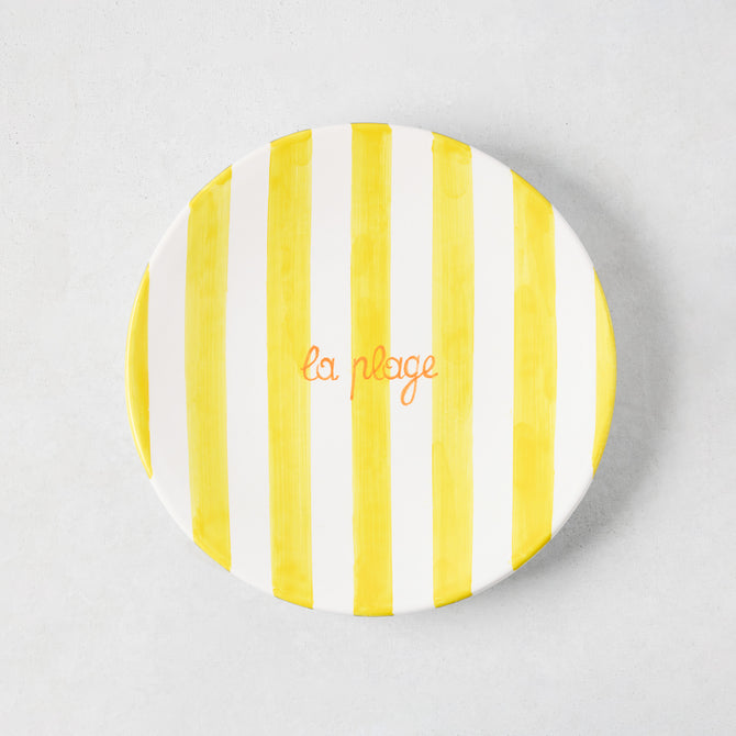 Hand-painted ceramic appetizer plate with bright yellow stripes and orange "la plage" text.