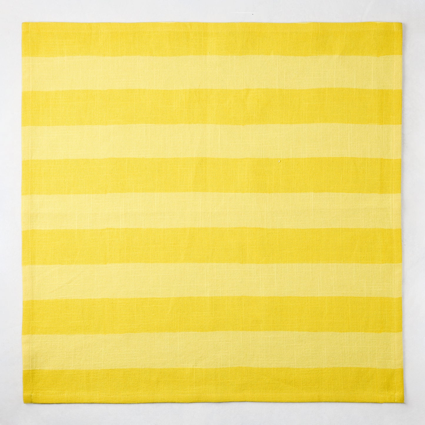 Yellow Tonal Hampton Stripe Cotton Napkin, 22" square, with bold two-toned yellow stripes.