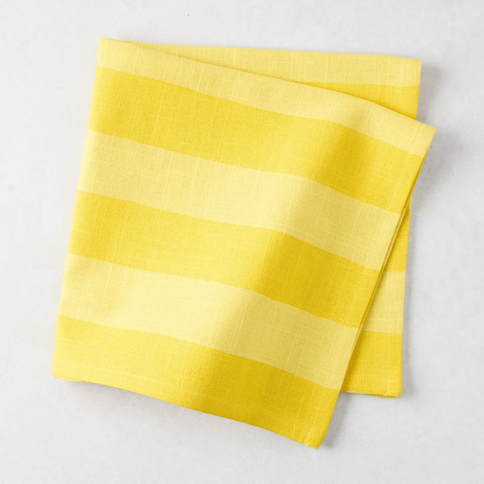 Folded Yellow Tonal Hampton Stripe Cotton Napkin, 22" square.