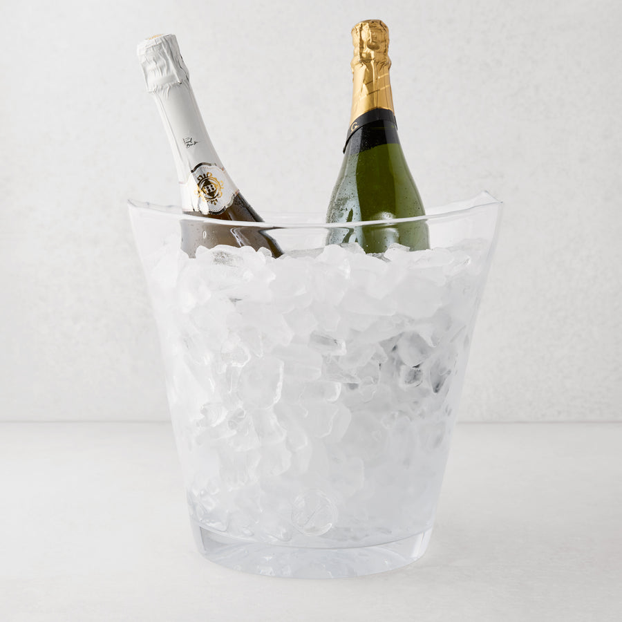 Zion oversized scissor-cut glass ice bucket with two champagne bottles chilling in ice.