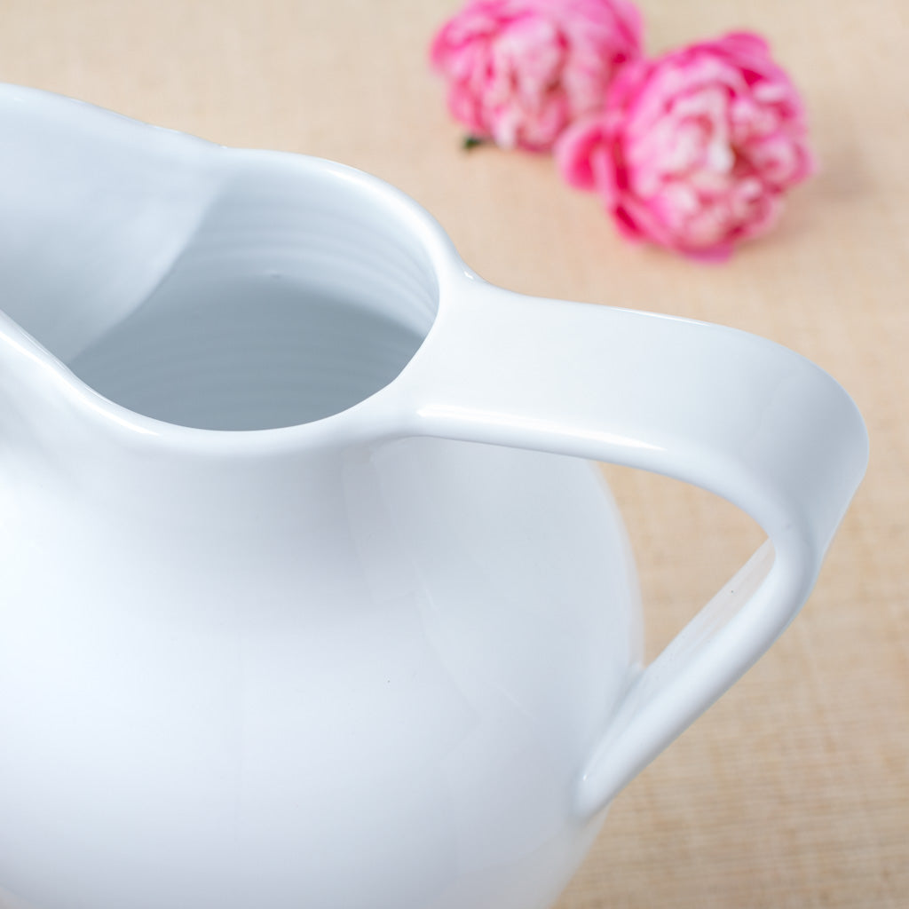 Handled white pitcher with large spout 
