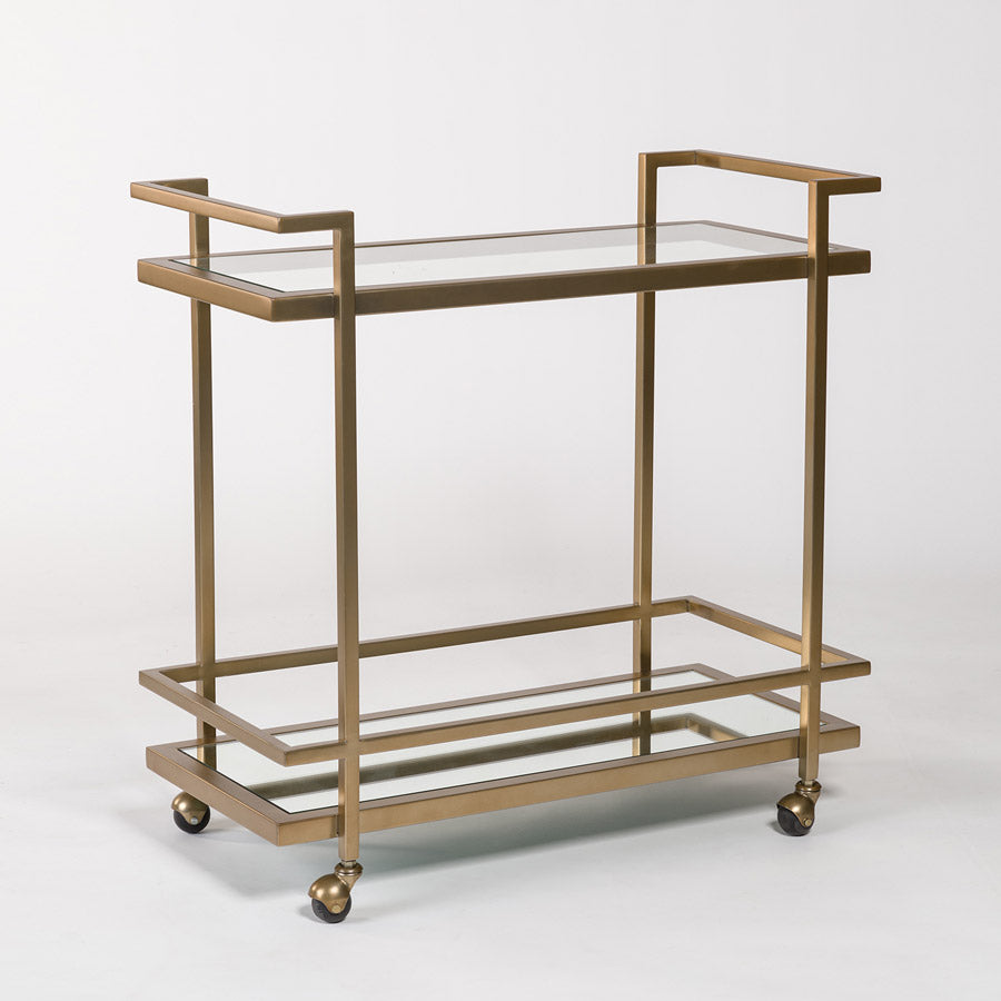 large brass and glass bar cart with two shelves
