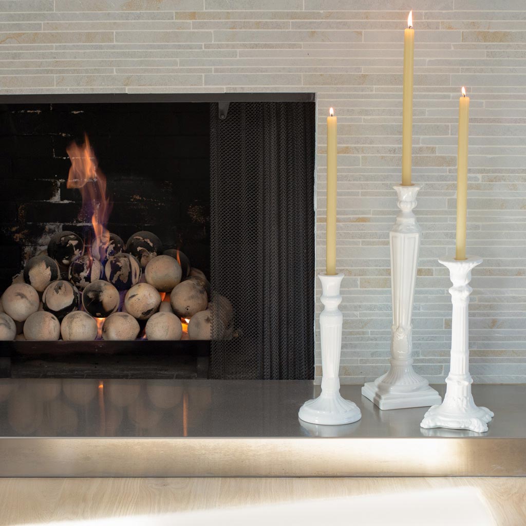 White Column Candlesticks in front of fireplace