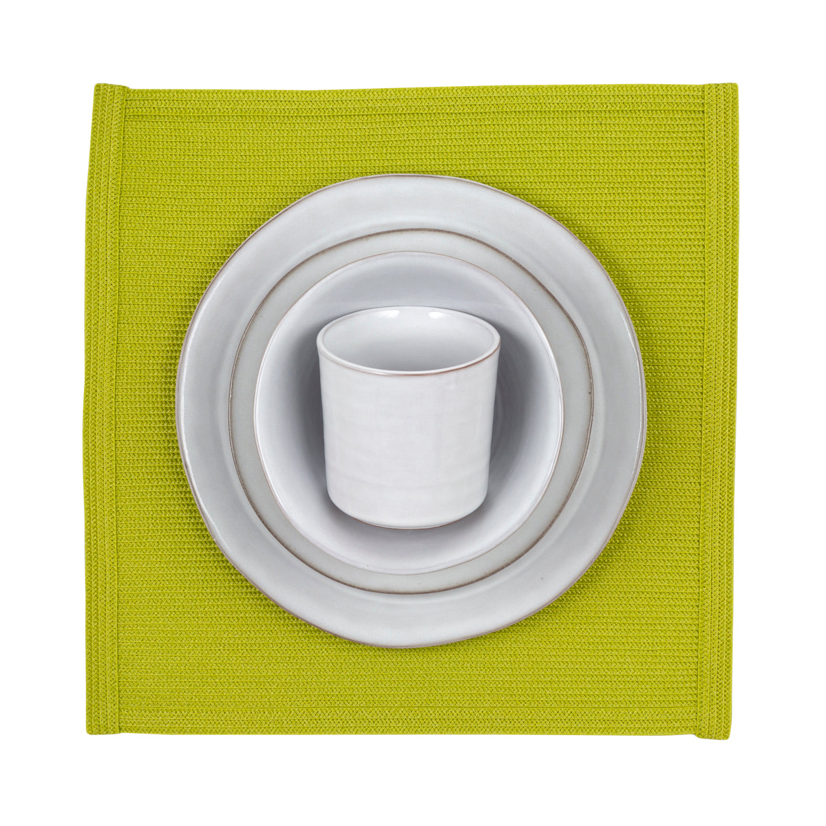 stone dinnerware collection with green placemat