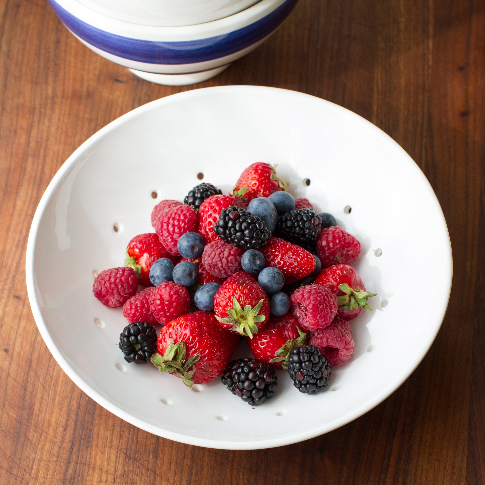 Hudson Grace White Ceramic Berry Bowl overhead with fresh straberries, blueberries and blackberries fruit