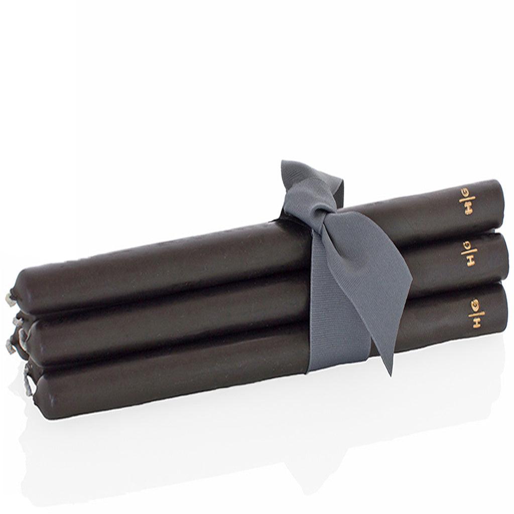 Three black 22" HG taper candles, hand-dipped paraffin, tied with a gray ribbon.