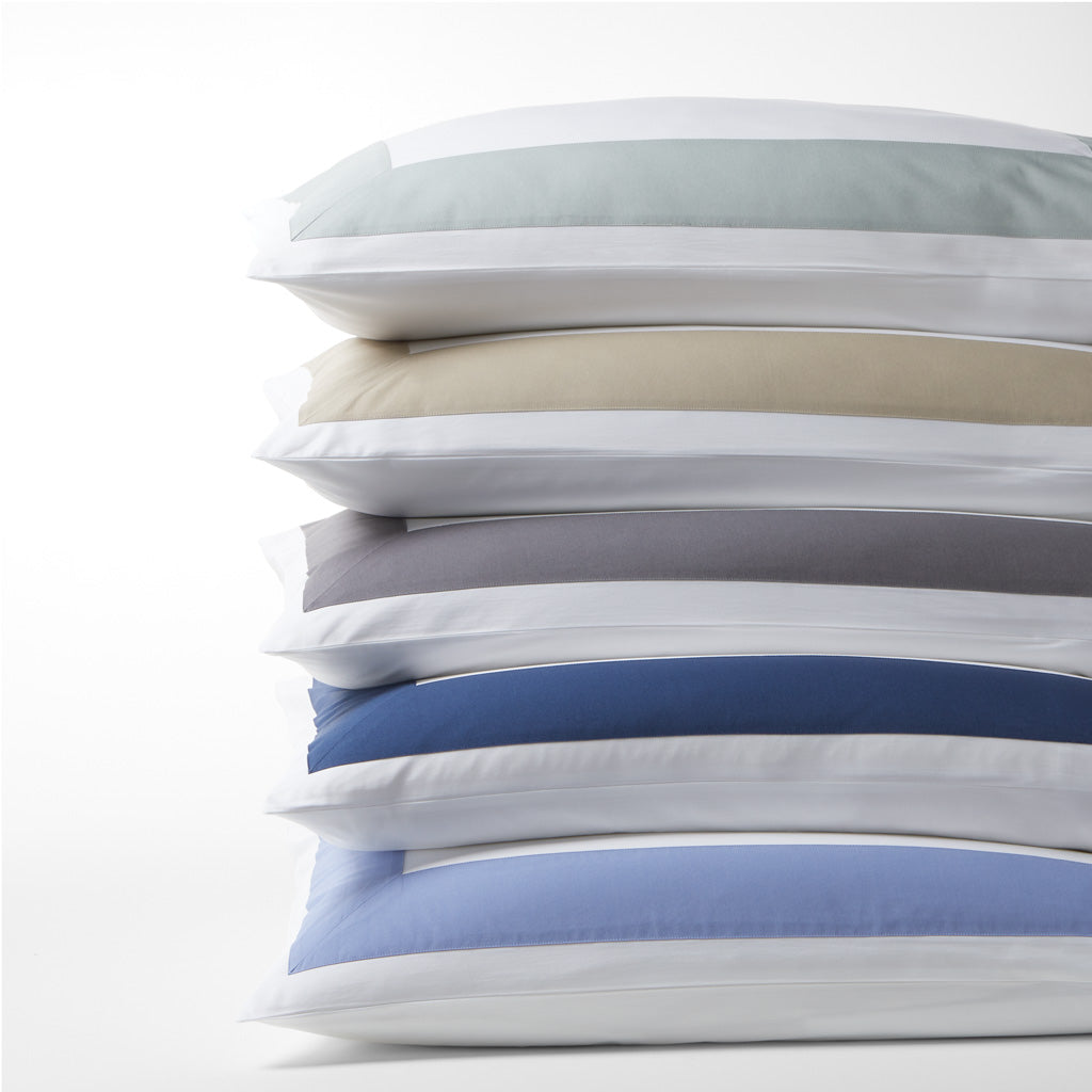 Stack of Blue Wide-Band Percale Pillow Shams with a 4" wide band, made from extra-long staple cotton.