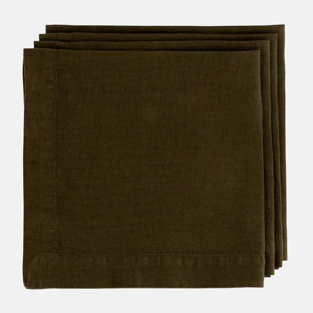 Stack of three Cedar HG Signature hand-dyed dark mossy green linen napkins, 22-inch square.