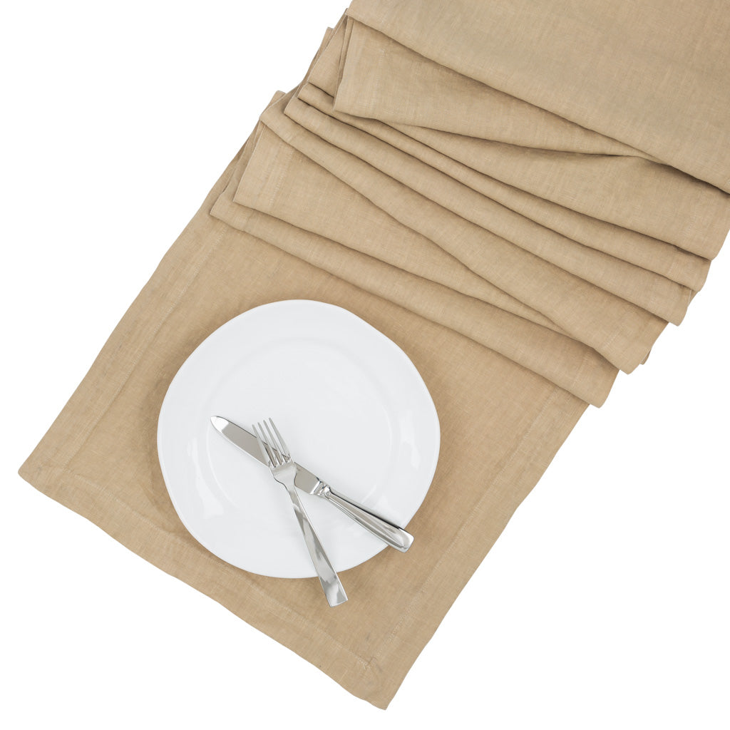 Chai HG Signature hand-dyed linen table runner, 18"x108", with a white plate and silverware.