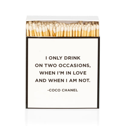 White "Coco Chanel" boxed matches with a quote, featuring long wooden matchsticks.