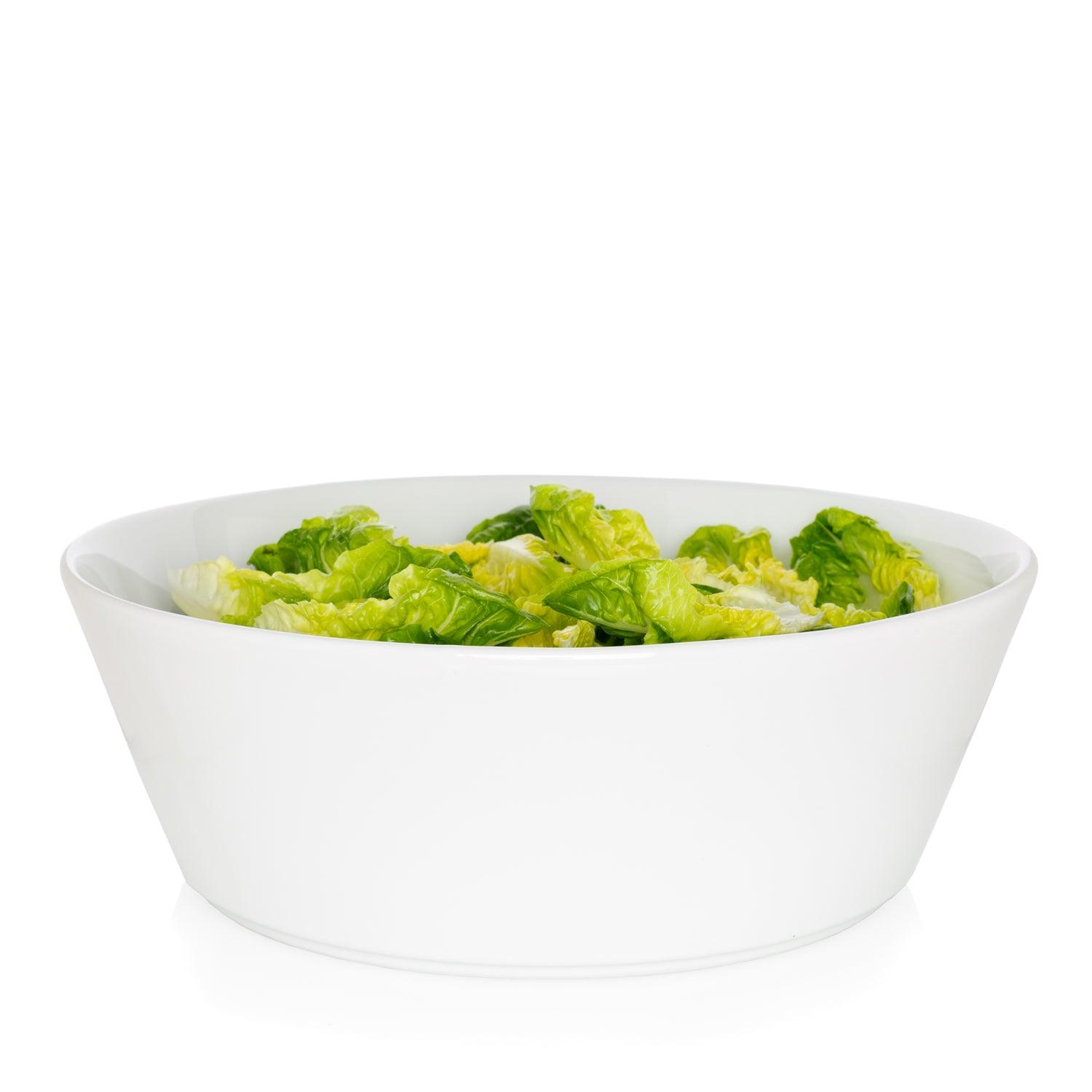 Corno Ceramic Serve Bowl, creamy white earthenware, 12.5" Dia, filled with green lettuce.