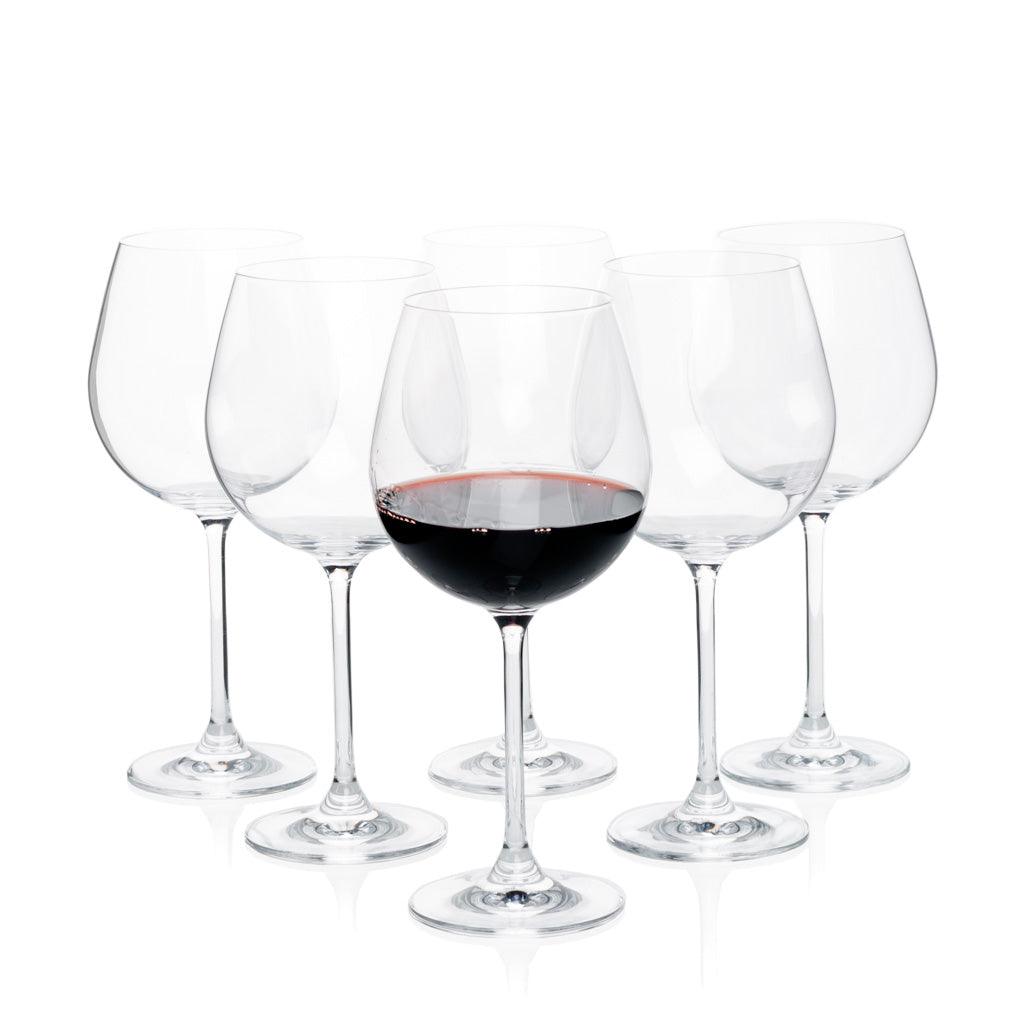 Set of 6 clear crystal Burgundy stem wine glasses, one filled with red wine.