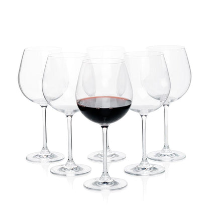 Set of 6 clear crystal Burgundy stem wine glasses, one filled with red wine.