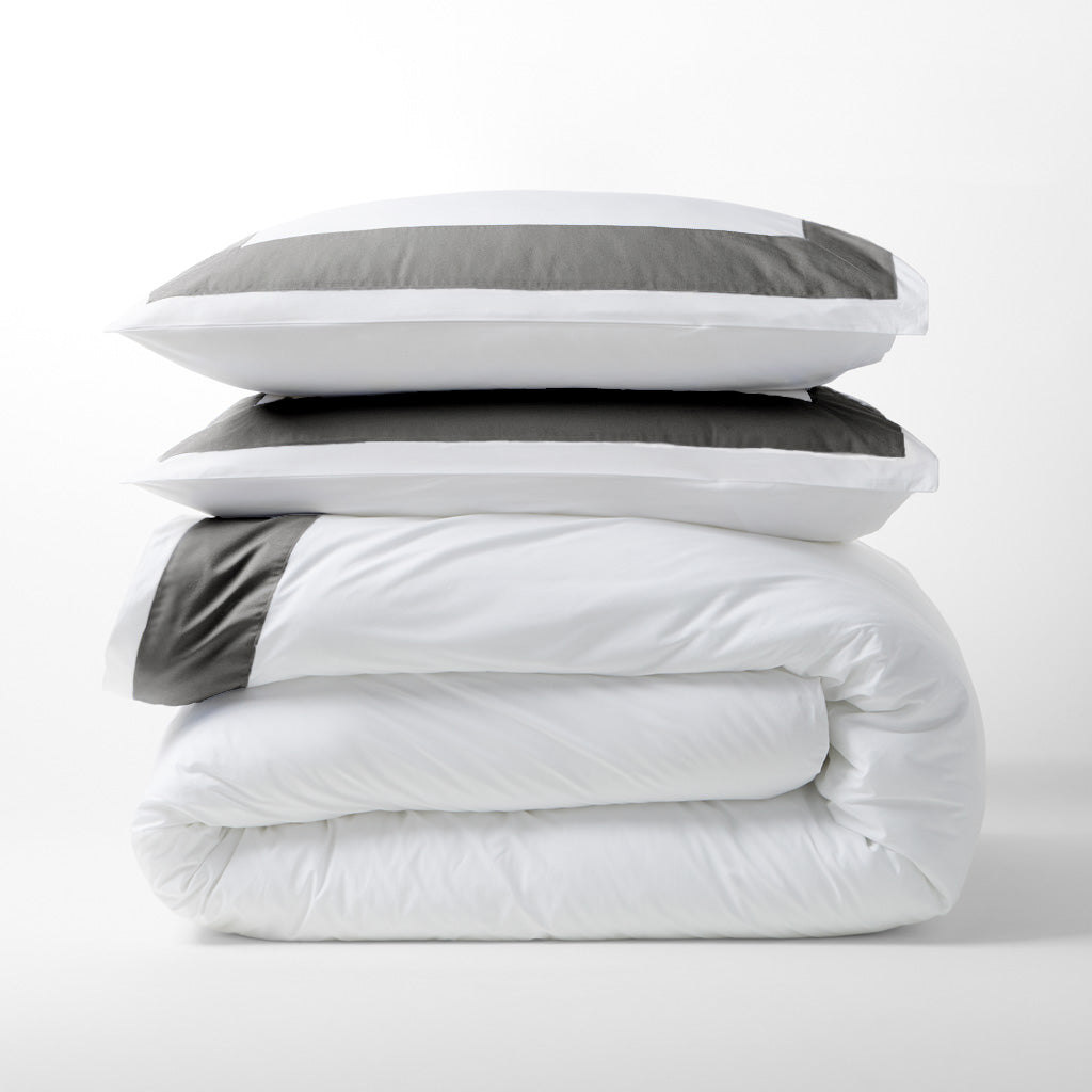 Dark Grey Wide-Band Percale Duvet Cover and shams, folded and stacked, with a 4" wide band.