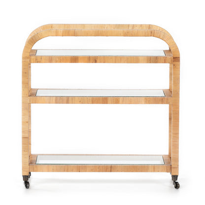 Dory Rattan Bar Cart with honey-finished rattan frame, three glass tiers, and wheels.