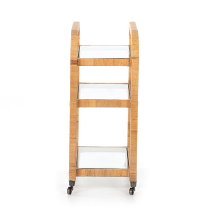 Dory Rattan Bar Cart, honey-finished rattan with three glass tiers and wheels.