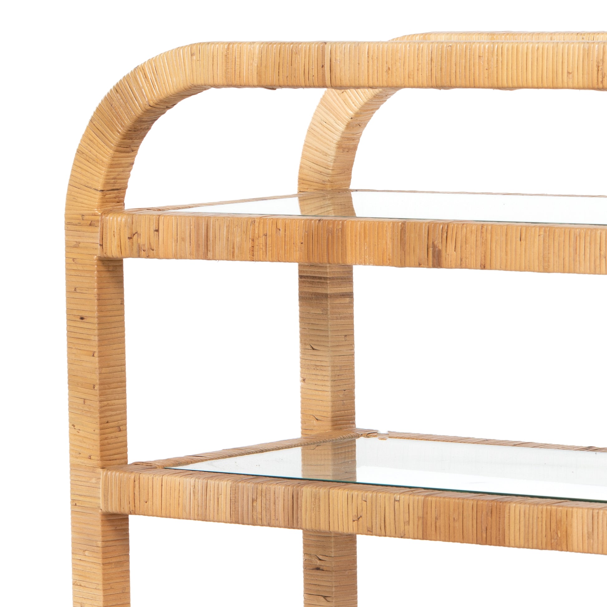 Dory Rattan Bar Cart, honey-finished rattan, three clear glass tiers, curved top handle.