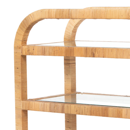 Dory Rattan Bar Cart, honey-finished rattan, three clear glass tiers, curved top handle.