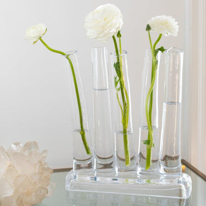 Elli Small Scissor-Cut Glass Vase with five clear tubes, holding white ranunculus flowers.